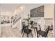 Dining area with a glass table, modern chairs and a staircase leading upstairs at 6102 S Owens Ct, Littleton, CO 80127