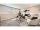 A stylish living room featuring a gray sofa, modern art, and natural light exudes comfort at 6102 S Owens Ct, Littleton, CO 80127