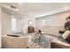 A cozy living room with gray carpet, modern furniture, and natural light offers a relaxing space at 6102 S Owens Ct, Littleton, CO 80127