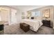 Cozy main bedroom showcasing a king-sized bed, and neutral decor for a relaxing retreat at 6102 S Owens Ct, Littleton, CO 80127