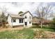 Backyard view of a two-story home featuring a spacious yard and a patio area at 1566 S Richfield Way, Aurora, CO 80017