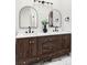 Bathroom features a modern double vanity, dark wood cabinets, and marble countertops at 1566 S Richfield Way, Aurora, CO 80017