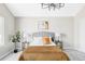 Neutral bedroom featuring an upholstered headboard, contemporary chandelier, and sleek side tables at 1566 S Richfield Way, Aurora, CO 80017