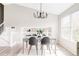 Bright dining room with modern chandelier, table set for four, and a large window at 1566 S Richfield Way, Aurora, CO 80017