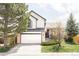 Charming two-story home featuring a brick and siding exterior with an attached two-car garage at 1566 S Richfield Way, Aurora, CO 80017