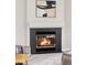 Close-up of the cozy fireplace with black tile and white mantle, creating a warm focal point at 1566 S Richfield Way, Aurora, CO 80017