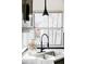 Close-up of a kitchen sink featuring stainless steel sink, modern fixtures and a bright window at 1566 S Richfield Way, Aurora, CO 80017