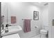 Bright bathroom featuring a floating sink, hexagon tile flooring, modern fixtures and neutral walls at 1930 Hooker St # 3, Denver, CO 80204