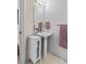 Bathroom featuring a pedestal sink, large mirror, neutral color palette, and hexagonal tile flooring at 1930 Hooker St # 3, Denver, CO 80204