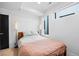 Minimalist bedroom with a cozy bed, soft lighting, and a large window offering natural light at 1930 Hooker St # 3, Denver, CO 80204