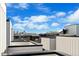 A rooftop view of Denver's skyline featuring white siding and modern architecture against a bright blue sky at 1930 Hooker St # 3, Denver, CO 80204