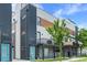 Modern townhome exterior with a blue door, black metal accents, and a small balcony with grilling equipment at 1930 Hooker St # 3, Denver, CO 80204