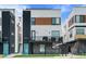 Modern townhouse exterior featuring brick accents, grilling balcony, and a vibrant blue front door at 1930 Hooker St # 3, Denver, CO 80204