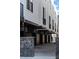 View of modern townhome garages and walkway, featuring brick accents and sleek architectural details at 1930 Hooker St # 3, Denver, CO 80204