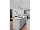 Bright kitchen with a large white island, stainless steel sink and faucet, and modern cabinetry at 1930 Hooker St # 3, Denver, CO 80204