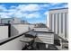 Enjoy outdoor cooking on this rooftop deck, complete with a modern grill and comfortable Adirondack chair at 1930 Hooker St # 3, Denver, CO 80204