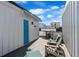 Rooftop deck featuring outdoor furniture, a grill, and a blue door with awning at 1930 Hooker St # 3, Denver, CO 80204