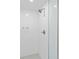 Walk-in shower showcasing white tiled walls, nickel fixtures, and glass doors at 1930 Hooker St # 3, Denver, CO 80204