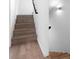 Modern staircase with hardwood steps, white walls, and stylish lighting for an inviting feel at 1930 Hooker St # 3, Denver, CO 80204