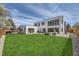 Modern home features a spacious lawn, outdoor seating, and large windows offering great views at 3083 S Garfield St, Denver, CO 80210