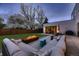 Cozy outdoor patio with comfortable seating, fire pit, and blooming trees create a relaxing ambiance at 3083 S Garfield St, Denver, CO 80210