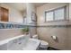 Charming bathroom with decorative tiles, pedestal sink, and toilet providing a functional yet stylish space at 3540 Vrain St, Denver, CO 80212
