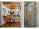 Stylish bathroom boasting wood cabinets, granite counters, dual sinks, and a glass-enclosed shower at 3540 Vrain St, Denver, CO 80212