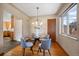 Charming dining room featuring hardwood floors, natural light, and open kitchen access at 3540 Vrain St, Denver, CO 80212