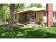 Well-maintained single-story home with a covered porch and lush green lawn at 3540 Vrain St, Denver, CO 80212