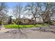 Charming brick home featuring mature trees, lush green lawn, and a welcoming front porch on a corner lot at 3540 Vrain St, Denver, CO 80212