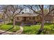 Charming brick home with well-manicured lawn, mature trees, and inviting front porch at 3540 Vrain St, Denver, CO 80212