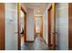 Bright hallway with stone floors leading to bedrooms and bathroom showcasing modern doors and trim at 3540 Vrain St, Denver, CO 80212