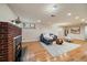 Open-concept living room featuring a brick fireplace, contemporary furniture, and ample natural light at 3540 Vrain St, Denver, CO 80212