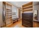 Spacious walk-in closet with custom shelving, storage drawers, and a mirrored door offering an organized space at 3540 Vrain St, Denver, CO 80212