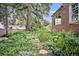 Landscaped backyard with lush greenery and stone path at 869 Vine St, Denver, CO 80206
