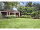 Landscaped backyard with brick pavilion and lush greenery at 869 Vine St, Denver, CO 80206