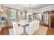Elegant dining room features a large table, chandelier, and hardwood floors at 869 Vine St, Denver, CO 80206