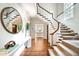 Elegant entry with hardwood floors and a grand staircase at 869 Vine St, Denver, CO 80206