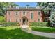 Brick home with landscaped lawn and walkway at 869 Vine St, Denver, CO 80206