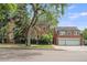 Brick home with attached garage and mature landscaping at 869 Vine St, Denver, CO 80206