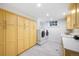 Bright laundry room featuring ample cabinetry and modern appliances at 869 Vine St, Denver, CO 80206