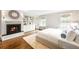 Main bedroom features a fireplace, built-in shelving, and hardwood floors at 869 Vine St, Denver, CO 80206