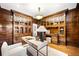 Home office with built-in wooden cabinetry and hardwood floors at 869 Vine St, Denver, CO 80206