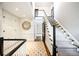Grand staircase with patterned runner and storage at 869 Vine St, Denver, CO 80206