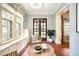 Bright sunroom with French doors and built-in seating at 869 Vine St, Denver, CO 80206