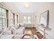 Bright sunroom features hardwood floors, comfy seating, and large windows at 869 Vine St, Denver, CO 80206