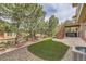 Backyard featuring artificial grass, stone landscaping, wooden stairs, and a private hot tub area at 1562 Suncrest Rd, Castle Rock, CO 80104