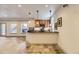 Inviting basement bar with wood countertop, tile flooring, and elegant pendant lighting at 1562 Suncrest Rd, Castle Rock, CO 80104