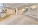 Spacious finished basement with carpeted flooring, bar, and stairs to the upper level at 1562 Suncrest Rd, Castle Rock, CO 80104