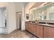 Well-lit bathroom featuring double sinks and a spacious countertop, with a doorway leading to another room at 1562 Suncrest Rd, Castle Rock, CO 80104